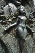 Bronze sculpture of a nude figure with flowing hair and draped fabric