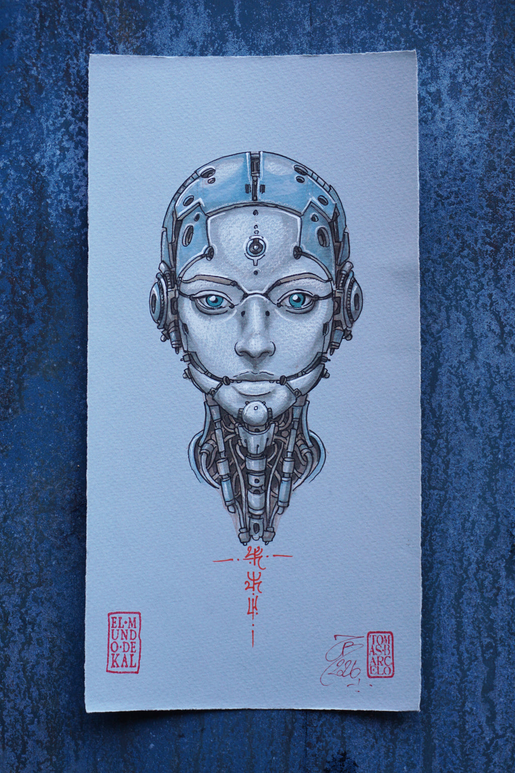 A square art print featuring a detailed illustration of a metallic humanoid robot face with glowing blue eyes, centered on textured blue paper. The print includes red Japanese calligraphy and two red artist stamps at the bottom.