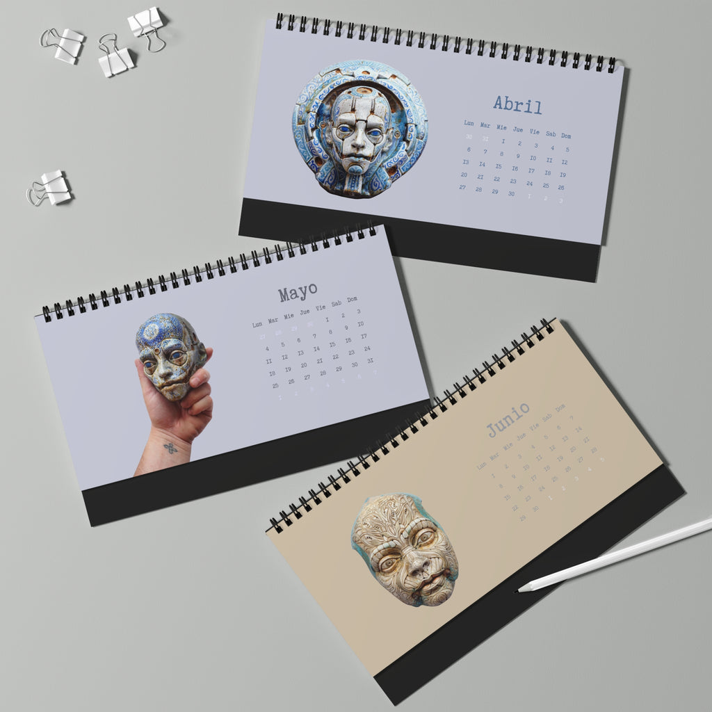 Three spiral-bound calendars with artistic designs on a gray background