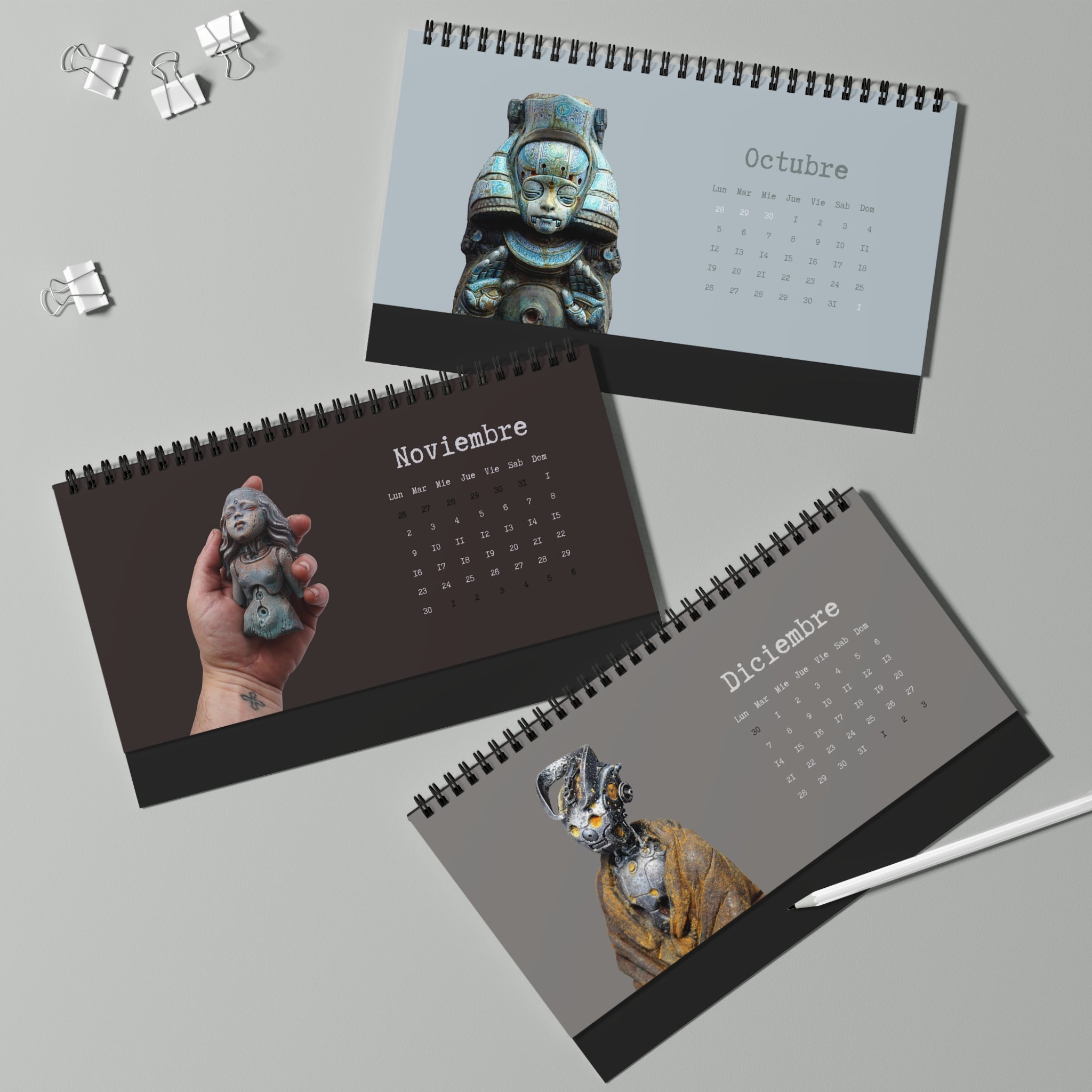 Three calendar pages showing different months with statues on a gray background